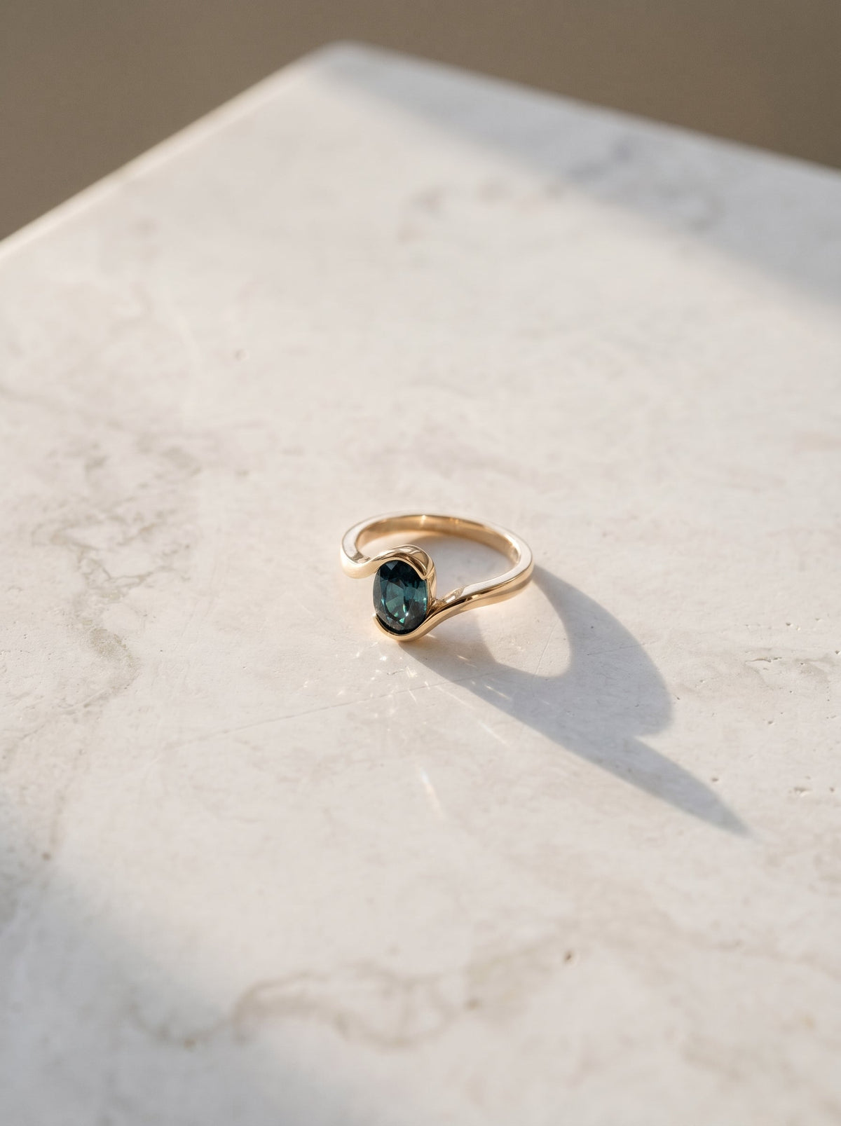 Oval Teal Sapphire Bezel Bypass Engagement Ring — styled